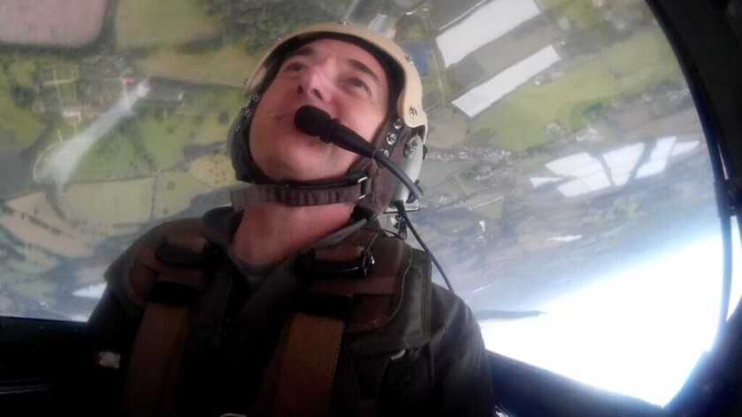 Author inverted in a Spitfire cockpit during aerobatics