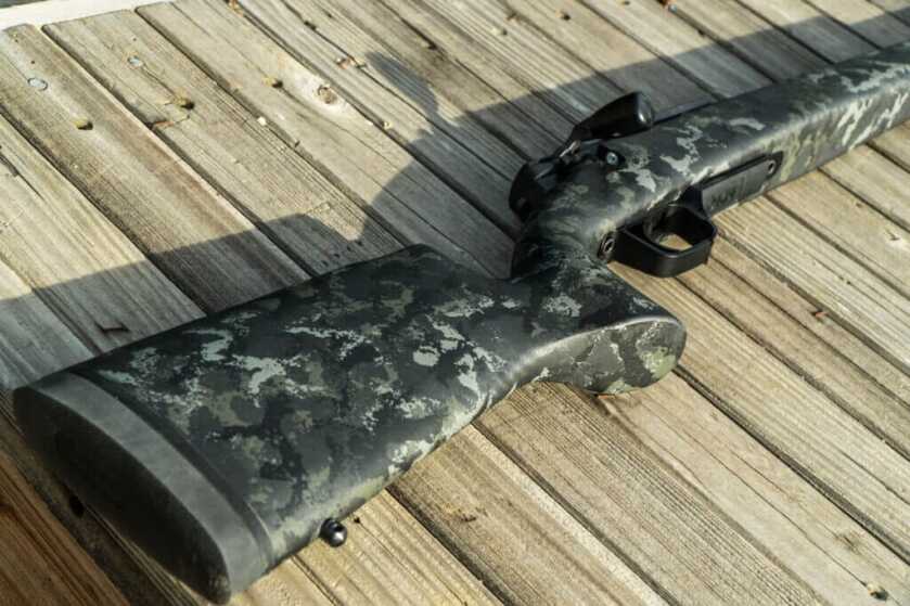Strasser RS 700 Tungsten colored Carbon Fiber stock laying on it's side