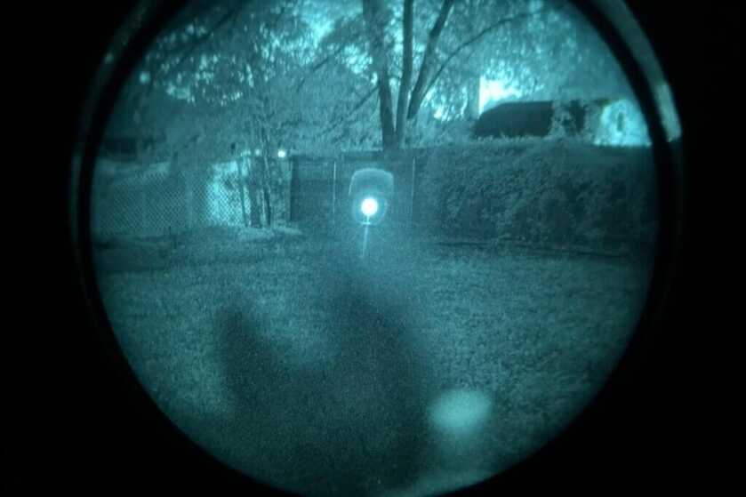 Looking through the reticle of a Vortex red dot using night vision