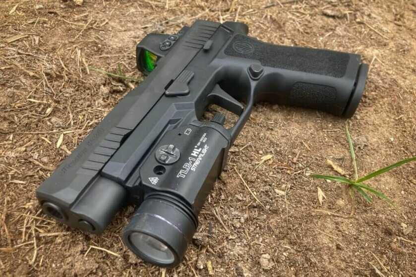 Pistol with weapon-mounted light set on the ground