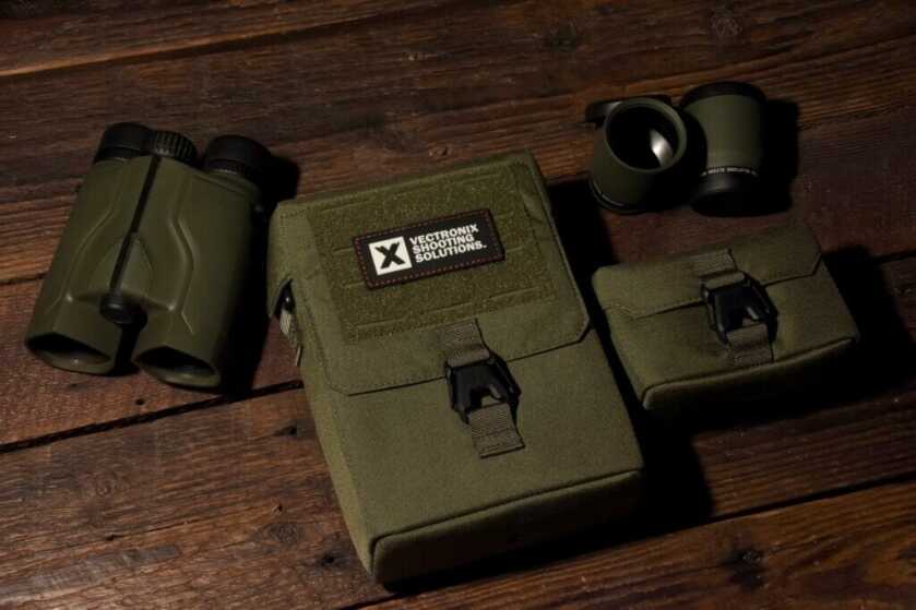 Vector X binoculars and case staged on a wooden background.