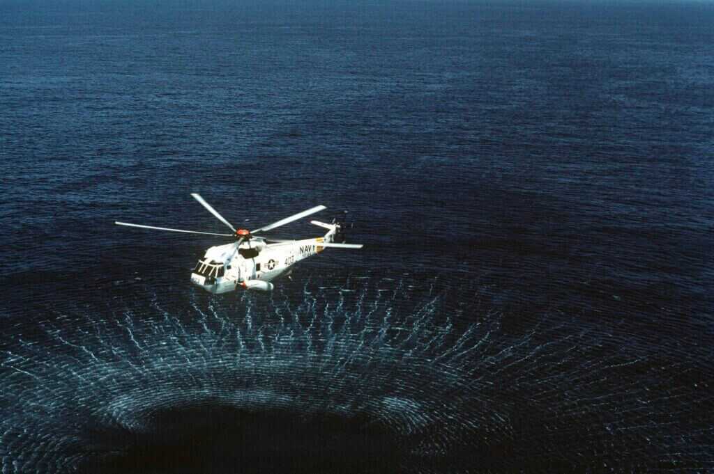 Anti submarine warfare helicopter flying above water