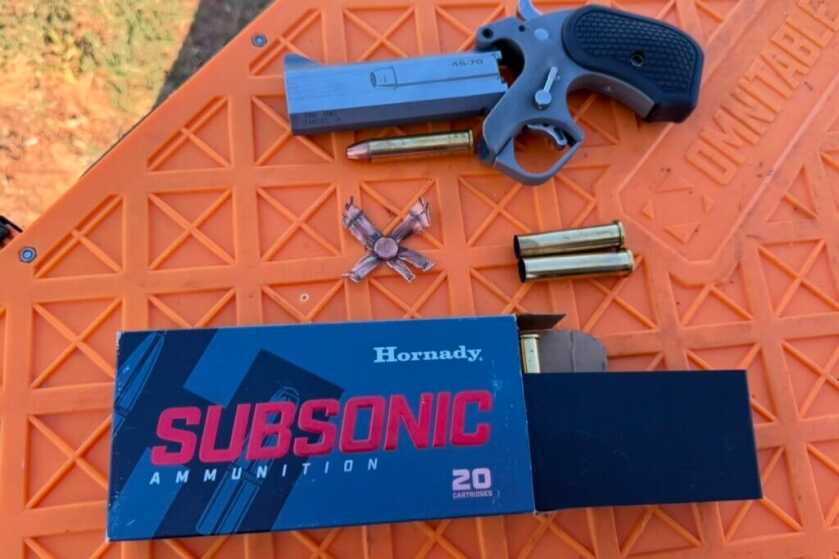 ammo and spent shells spread out on a table with handgun
