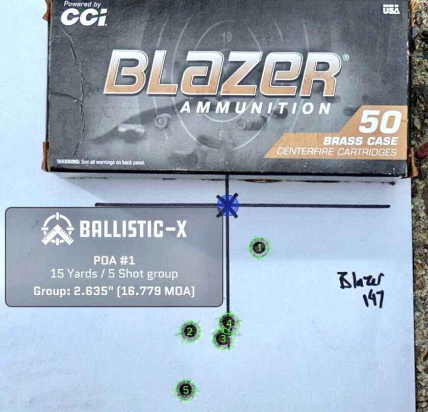 A used pistol target with a box of ammunition on top shows how accurate it is.