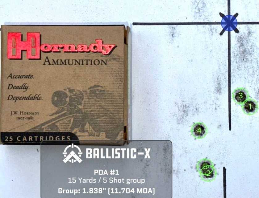 A used pistol target with a box of ammunition on top shows how accurate it is.