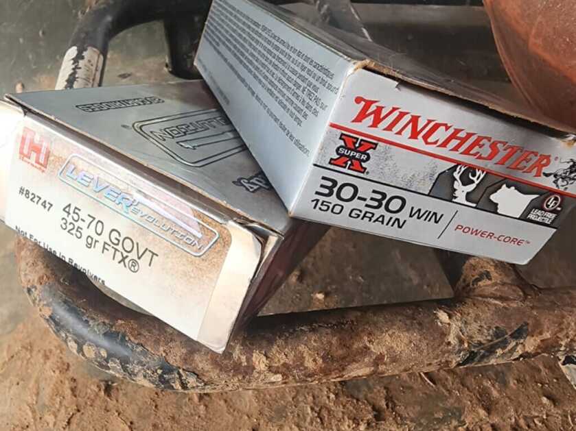 assorted lever-action hunting ammunition including 45-70 and 30-30 with boxes
