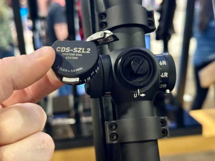 Close up look at the turret system of a rifle scope.