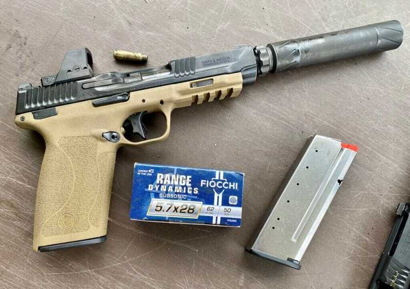 Suppressed handgun with 5.7x28mm ammo and a magazine