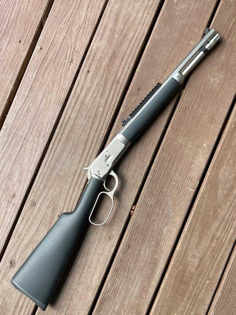 Taylor & Company Alaskan Takedown – The Ultimate Lever Gun Taylor and Company Alaskan lever action rifle laid on vintage wood