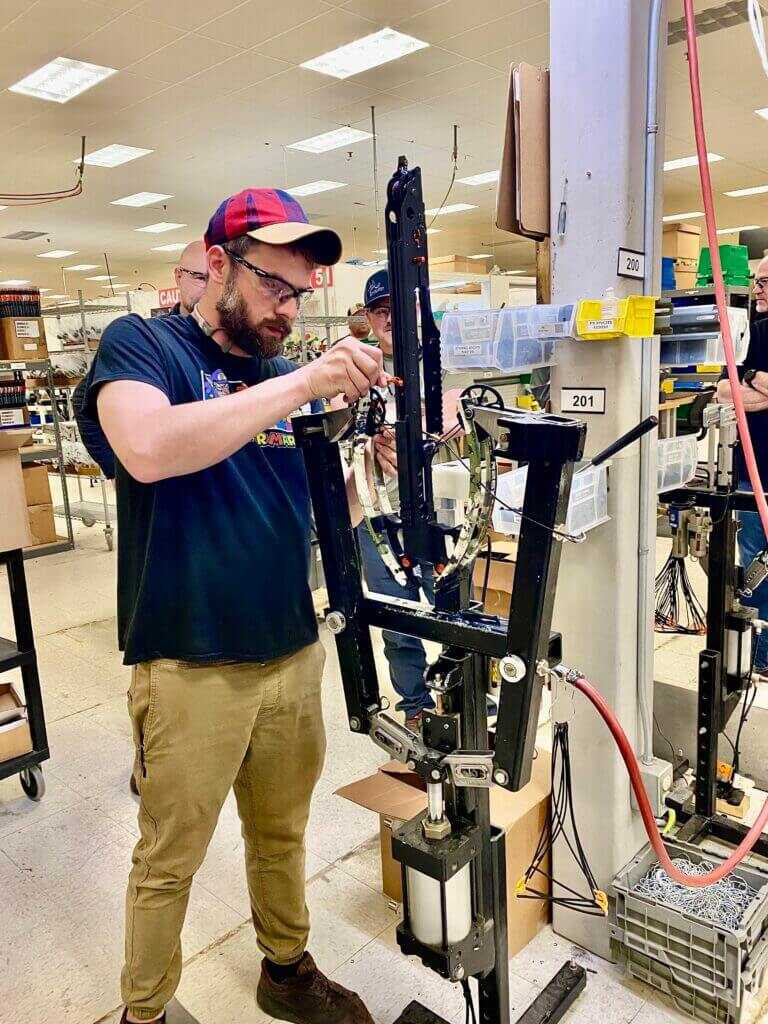 Ravin employee assembling a crossbow.